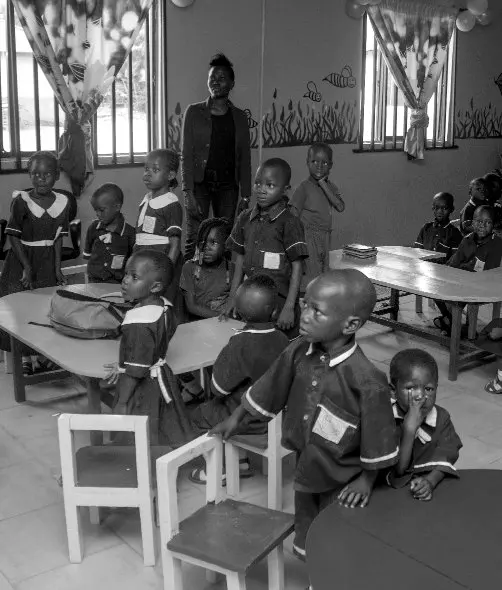 Young pupils in school uniforms in a brightly decorated classroom