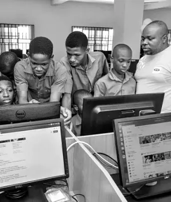 Students working together at computers in a school computer lab